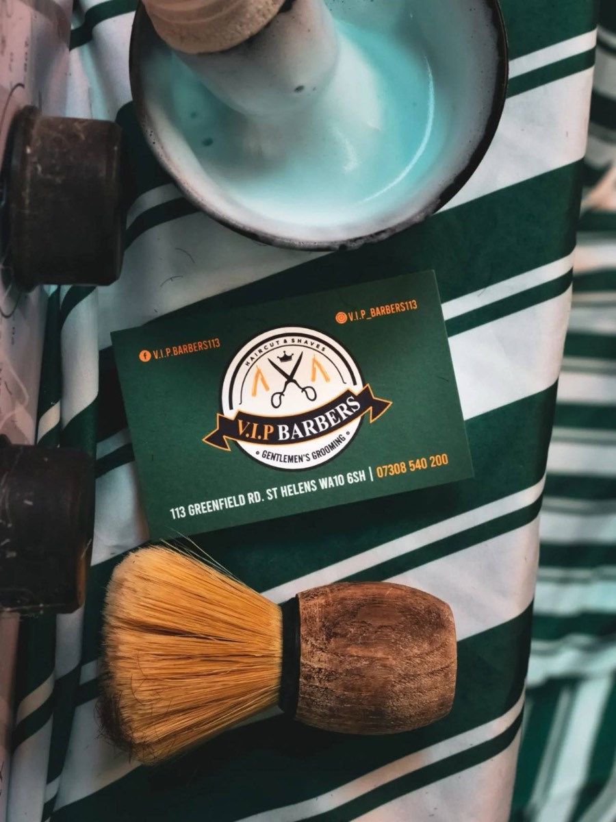 V.I.P Barbers business card with a shaving brush